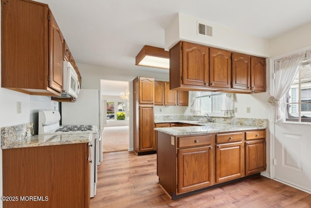 1524 Quince Pl, Toms River, NJ 08755 - kitchen with white appliances, brown cabinets, and healthy amount of natural light
