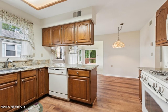 1524 Quince Pl, Toms River, NJ 08755 - kitchen featuring white appliances, a sink, brown cabinetry, and a peninsula