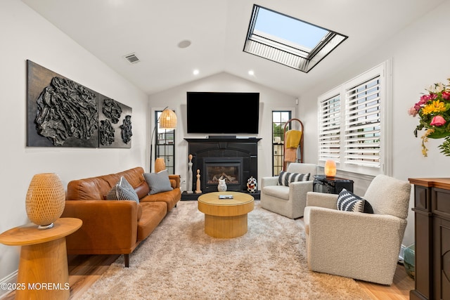 7 Carlisle Ct, Hazlet, NJ 07730 - living room featuring a skylight, wood finished floors, vaulted ceiling, a fireplace with flush hearth, and recessed lighting
