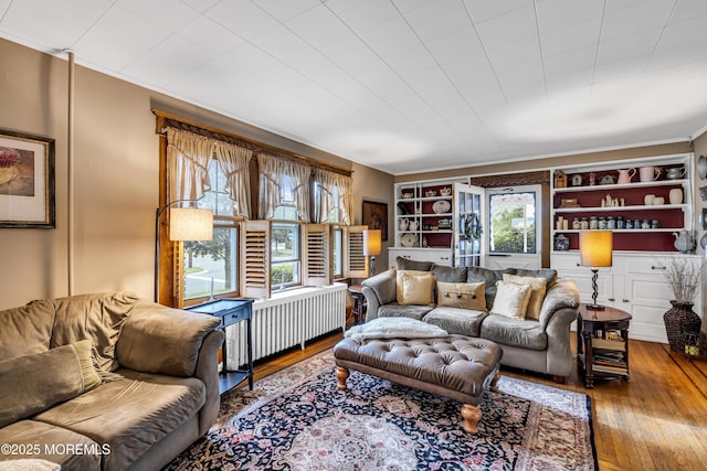 302 Chewalla Blvd, Hamilton, NJ 08619 - living room with radiator, hardwood / wood-style floors, ornamental molding, and built in shelves