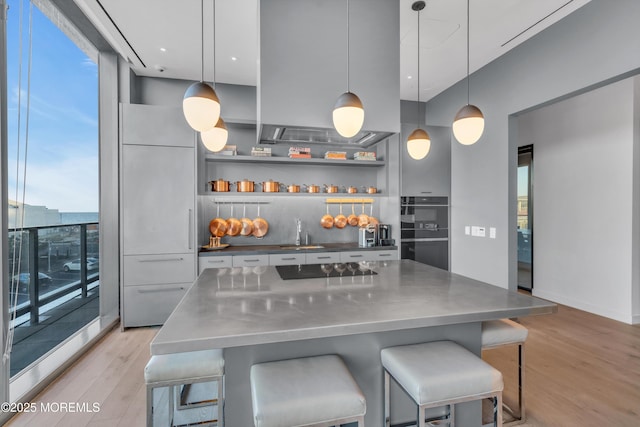 1101 Ocean Ave Unit 1403, Asbury Park, NJ 07712 - kitchen with stainless steel countertops, light wood finished floors, a sink, and black appliances