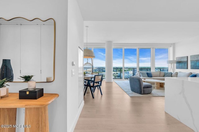 1101 Ocean Ave Unit 1403, Asbury Park, NJ 07712 - living area with light wood-style floors, healthy amount of natural light, floor to ceiling windows, and baseboards