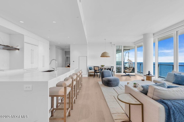 1101 Ocean Ave Unit 1403, Asbury Park, NJ 07712 - living area with light wood-style flooring, plenty of natural light, a water view, recessed lighting, and floor to ceiling windows