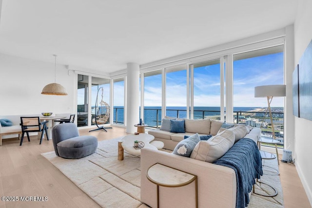 1101 Ocean Ave Unit 1403, Asbury Park, NJ 07712 - living room featuring a water view, light wood-style flooring, and floor to ceiling windows