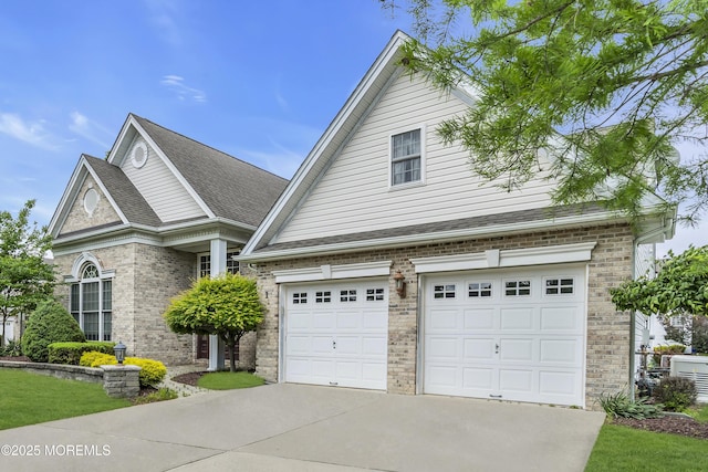 1 Lattimore Ct, Freehold, NJ 07728 - view of front of home with concrete driveway, brick siding, and a garage