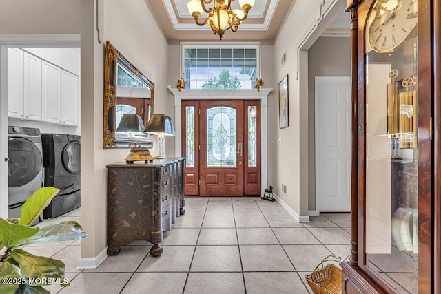 1 Lattimore Ct, Freehold, NJ 07728 - foyer entrance featuring washer and clothes dryer, a chandelier, light tile patterned floors, crown molding, and baseboards