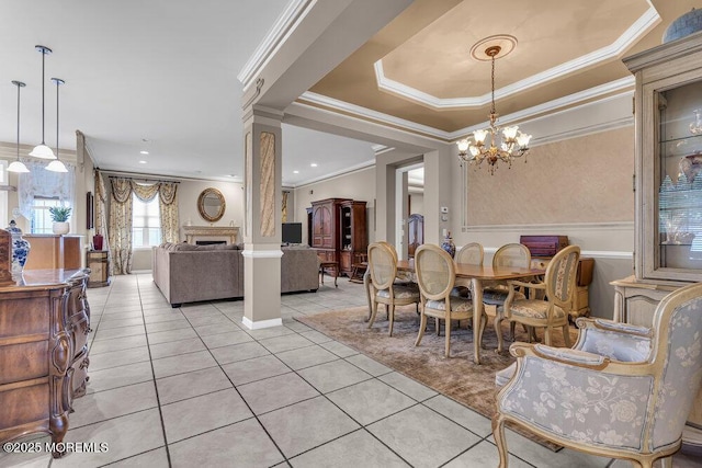 1 Lattimore Ct, Freehold, NJ 07728 - dining area with light tile patterned floors, a chandelier, crown molding, ornate columns, and a fireplace