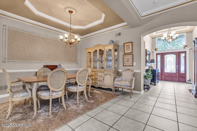 1 Lattimore Ct, Freehold, NJ 07728 - dining space featuring a chandelier, a raised ceiling, light tile patterned floors, ornamental molding, and arched walkways