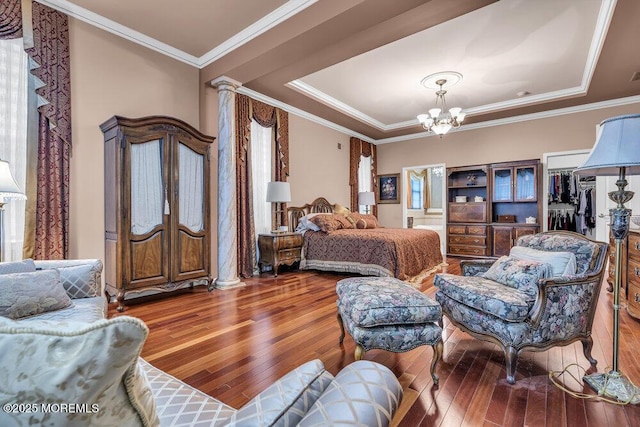 1 Lattimore Ct, Freehold, NJ 07728 - bedroom featuring hardwood / wood-style flooring, a chandelier, a tray ceiling, ornate columns, and crown molding