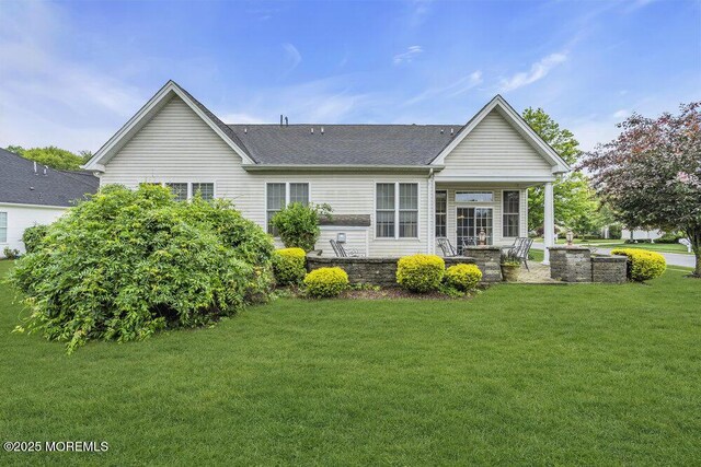 1 Lattimore Ct, Freehold, NJ 07728 - back of house with a lawn and a shingled roof