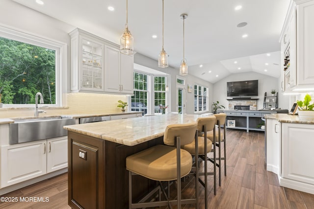 16 Wildflower Ct, Manalapan, NJ 07726 - kitchen featuring a sink, white cabinets, light stone counters, recessed lighting, and lofted ceiling