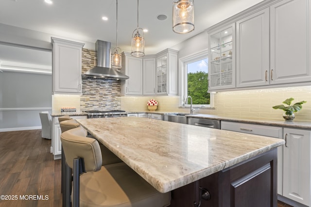 16 Wildflower Ct, Manalapan, NJ 07726 - kitchen with wall chimney exhaust hood, a center island, a sink, dark wood finished floors, and glass insert cabinets