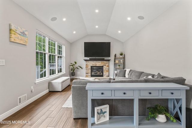 16 Wildflower Ct, Manalapan, NJ 07726 - living room with vaulted ceiling, a stone fireplace, wood finished floors, and baseboards