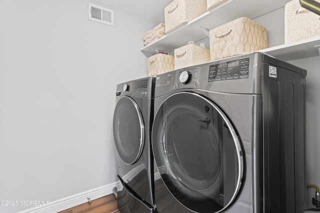 16 Wildflower Ct, Manalapan, NJ 07726 - laundry room with independent washer and dryer, baseboards, and wood finished floors
