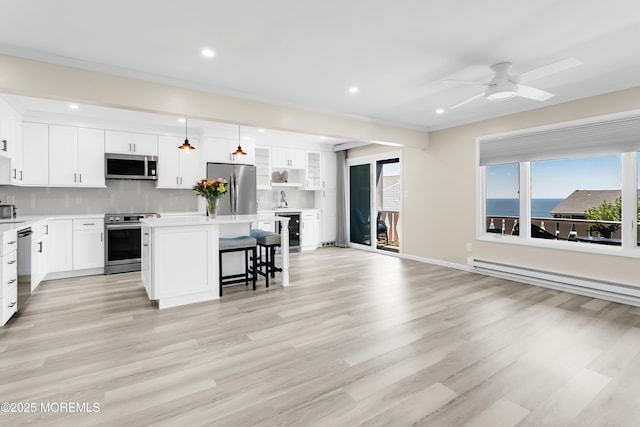 J4 Twinlights Ct, Highlands, NJ 07732 - kitchen featuring stainless steel appliances, a kitchen bar, a kitchen island, wine cooler, and white cabinetry