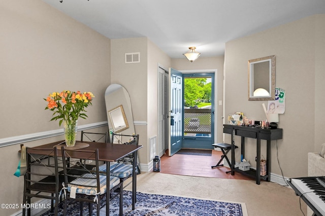 foyer with carpet floors and baseboards