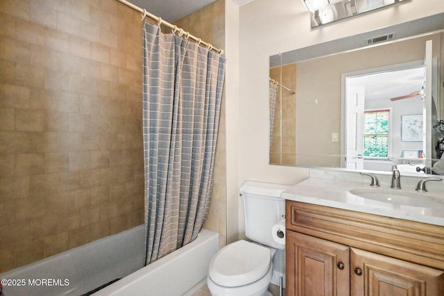 full bathroom featuring shower / bath combo, toilet, vanity, and a ceiling fan