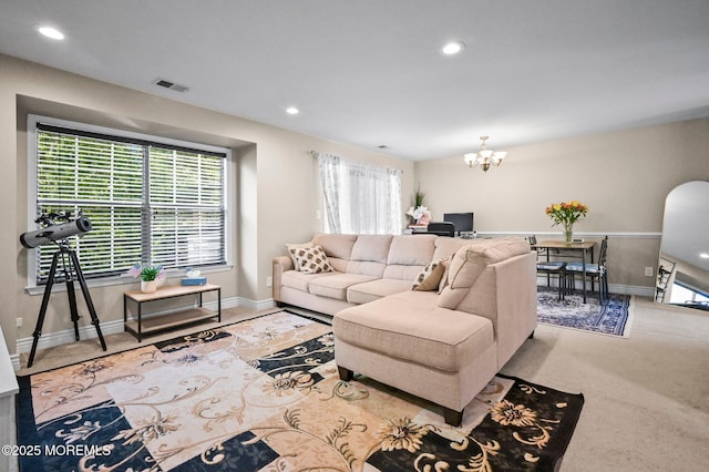 carpeted living area with a chandelier, baseboards, and recessed lighting