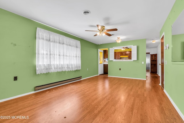 11 Lexington Dr Unit A, Whiting, NJ 08759 - unfurnished living room with a baseboard heating unit, ceiling fan, wood finished floors, and baseboards