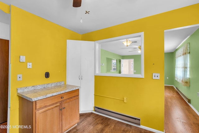 11 Lexington Dr Unit A, Whiting, NJ 08759 - kitchen featuring a ceiling fan, baseboard heating, dark wood-style flooring, and light countertops