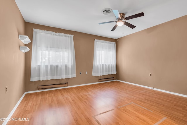 11 Lexington Dr Unit A, Whiting, NJ 08759 - empty room featuring a baseboard heating unit, a baseboard radiator, ceiling fan, wood finished floors, and baseboards