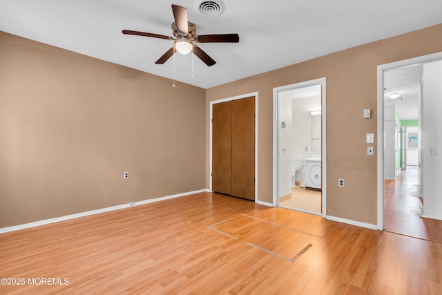 11 Lexington Dr Unit A, Whiting, NJ 08759 - unfurnished bedroom featuring washer / clothes dryer, light wood finished floors, baseboards, and connected bathroom