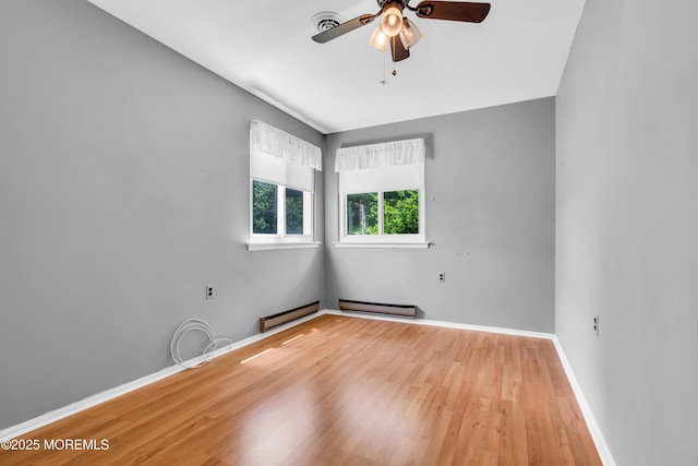 11 Lexington Dr Unit A, Whiting, NJ 08759 - unfurnished room with wood finished floors, a ceiling fan, a baseboard radiator, and baseboards
