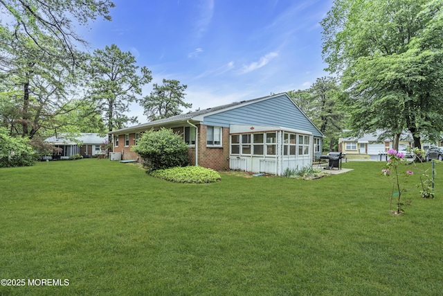 11 Lexington Dr Unit A, Whiting, NJ 08759 - rear view of house with brick siding and a yard