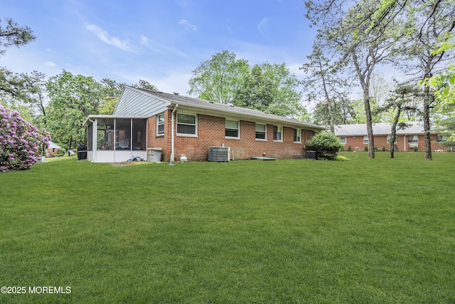 11 Lexington Dr Unit A, Whiting, NJ 08759 - rear view of house featuring a sunroom, a yard, central AC unit, and brick siding