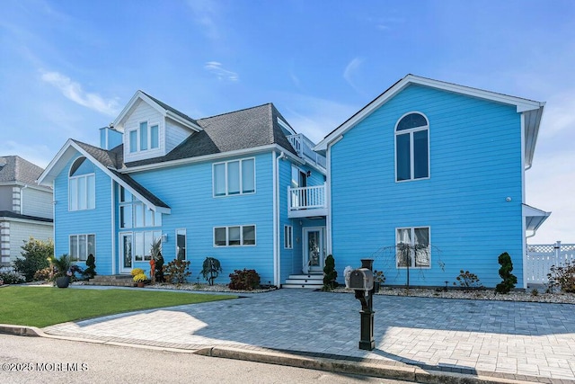 3504 Churchill Dr, Toms River, NJ 08753 - traditional-style home with a balcony, a front yard, and a patio area