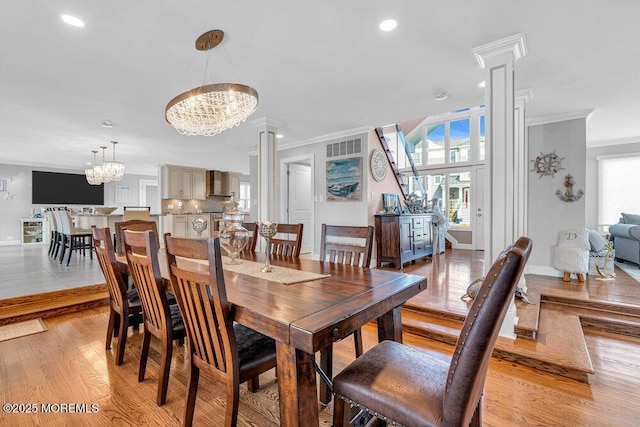 3504 Churchill Dr, Toms River, NJ 08753 - dining area with a chandelier, decorative columns, ornamental molding, light wood finished floors, and baseboards