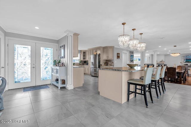 3504 Churchill Dr, Toms River, NJ 08753 - kitchen with stainless steel refrigerator with ice dispenser, a chandelier, a kitchen island, dark stone counters, and french doors