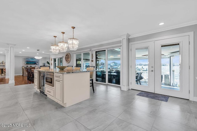 3504 Churchill Dr, Toms River, NJ 08753 - kitchen featuring french doors, crown molding, light stone countertops, a kitchen island, and a chandelier