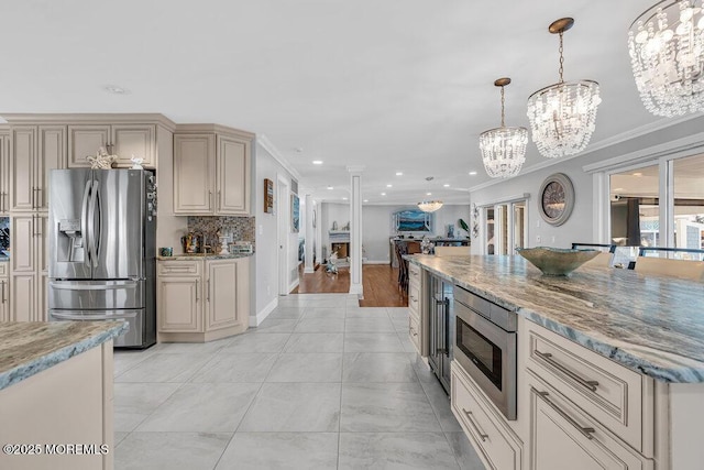 3504 Churchill Dr, Toms River, NJ 08753 - kitchen with appliances with stainless steel finishes, a chandelier, recessed lighting, pendant lighting, and cream cabinetry