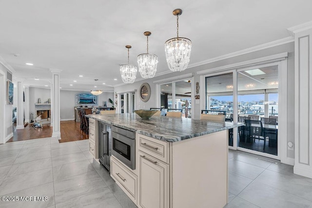 3504 Churchill Dr, Toms River, NJ 08753 - kitchen with a chandelier, stainless steel microwave, ornamental molding, stone countertops, and a kitchen island