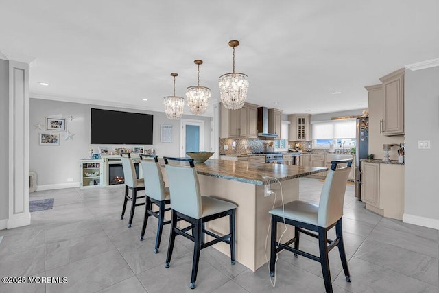 3504 Churchill Dr, Toms River, NJ 08753 - kitchen featuring wall chimney range hood, appliances with stainless steel finishes, a chandelier, a breakfast bar, and glass insert cabinets