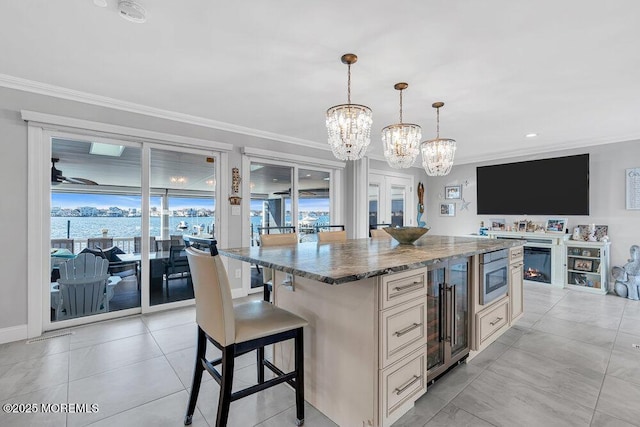 3504 Churchill Dr, Toms River, NJ 08753 - kitchen featuring beverage cooler, a chandelier, dark stone counters, stainless steel microwave, and ornamental molding