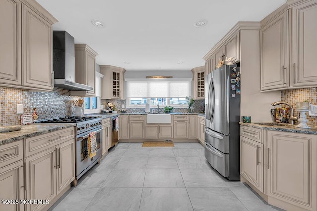 3504 Churchill Dr, Toms River, NJ 08753 - kitchen with stainless steel appliances, wall chimney exhaust hood, decorative backsplash, cream cabinetry, and a sink
