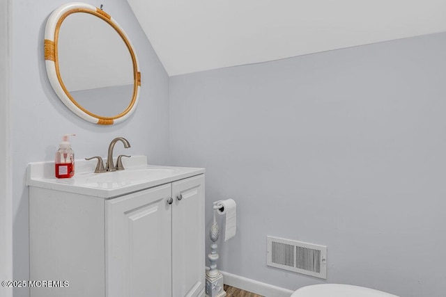 3504 Churchill Dr, Toms River, NJ 08753 - bathroom featuring lofted ceiling, vanity, wood finished floors, and baseboards
