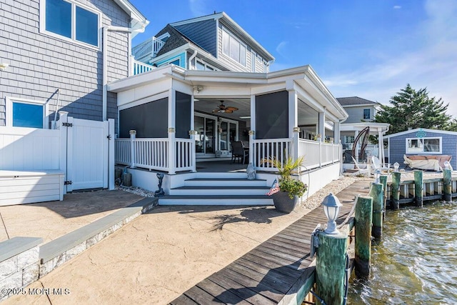 3504 Churchill Dr, Toms River, NJ 08753 - view of front of house featuring a ceiling fan, a water view, a sunroom, and a boat dock