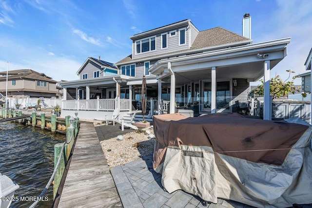 3504 Churchill Dr, Toms River, NJ 08753 - rear view of house featuring roof with shingles, a patio, and a water view