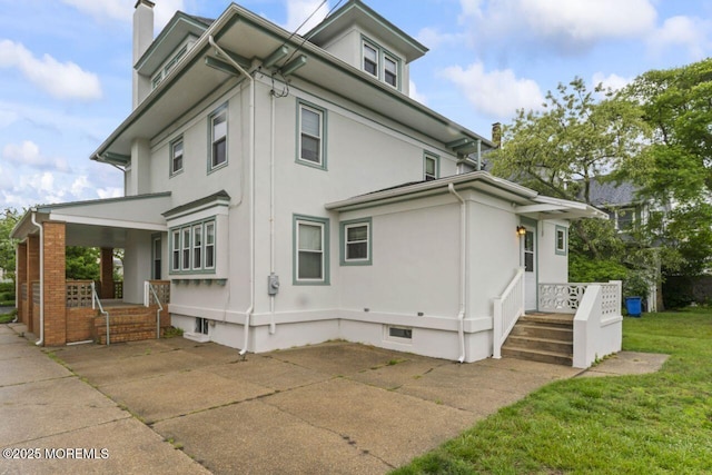 208 4th Ave, Belmar, NJ 07719 - view of property exterior with a chimney, a lawn, stucco siding, and a porch
