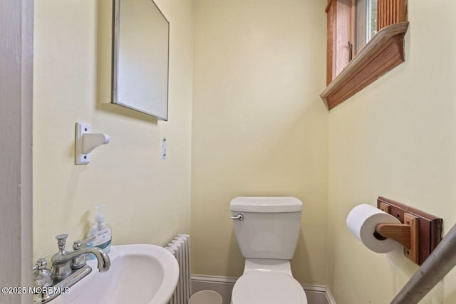 208 4th Ave, Belmar, NJ 07719 - bathroom with radiator heating unit, a sink, toilet, and baseboards