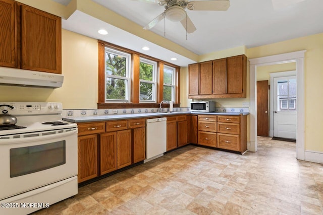 208 4th Ave, Belmar, NJ 07719 - kitchen featuring white appliances, under cabinet range hood, brown cabinetry, healthy amount of natural light, and recessed lighting