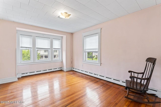 208 4th Ave, Belmar, NJ 07719 - unfurnished room featuring a baseboard heating unit and hardwood / wood-style flooring