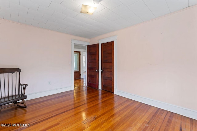 208 4th Ave, Belmar, NJ 07719 - empty room with wood finished floors and baseboards