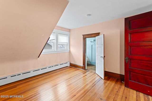 208 4th Ave, Belmar, NJ 07719 - unfurnished bedroom with baseboard heating, light wood-style flooring, and baseboards