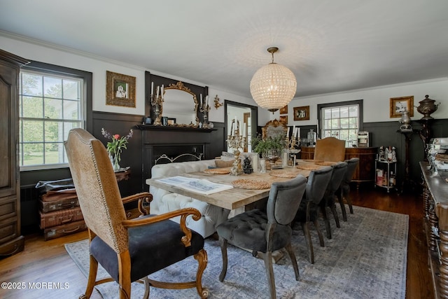135 Rumson Rd, Rumson, NJ 07760 - dining area with wood finished floors, a chandelier, wainscoting, crown molding, and plenty of natural light