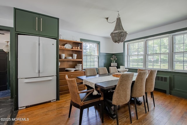135 Rumson Rd, Rumson, NJ 07760 - dining area with radiator heating unit, light wood-style flooring, and a chandelier