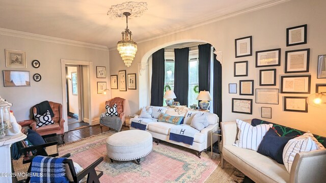 130 Main St, Keyport, NJ 07735 - living room with arched walkways, crown molding, wood finished floors, and a chandelier